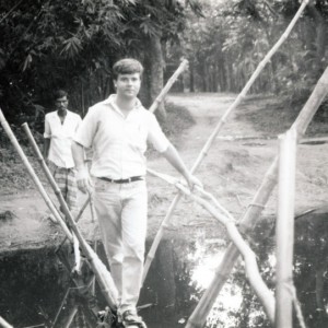 The author crossing a bamboo bridge in Bangladesh in 1993